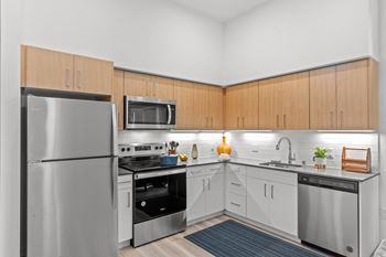 a kitchen with stainless steel appliances and white cabinetry